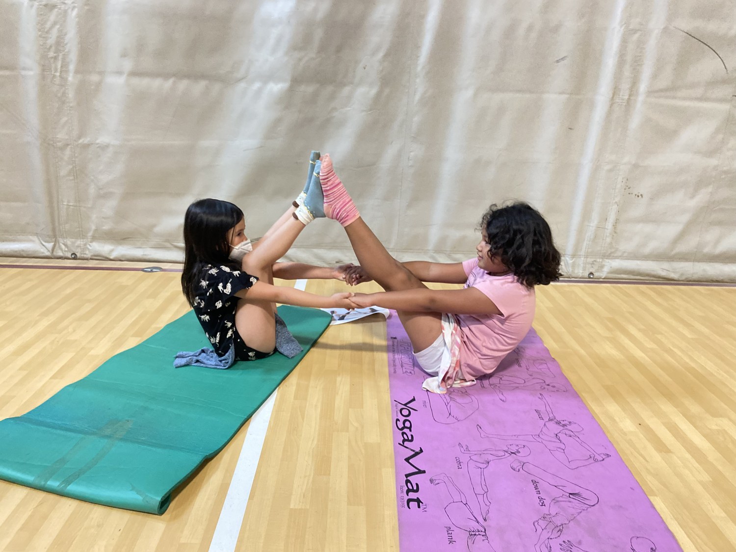 Royal Athletes yoga — partner stretch